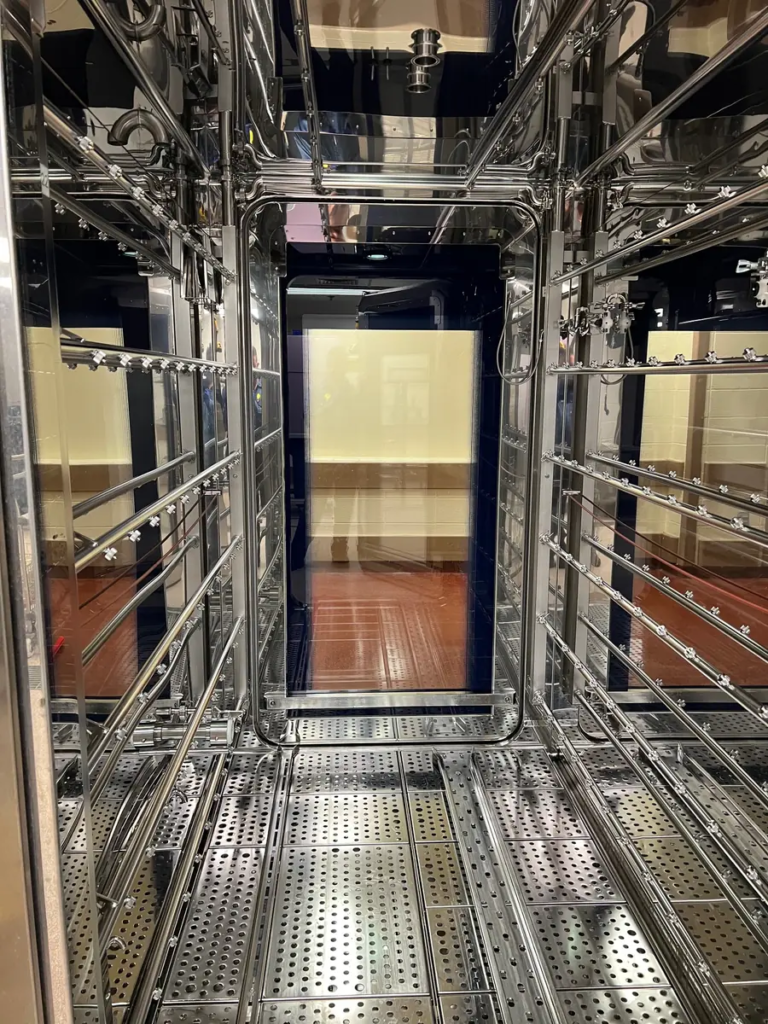 Clean stainless interior of a cage and rack washer