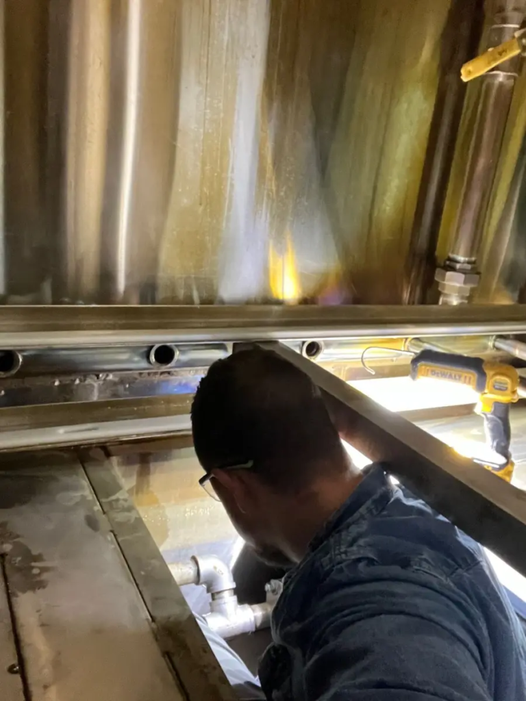 Adam Stonaker working inside a washer